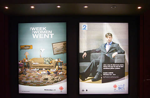 Two billboards in illuminated caissons: One for â€˜The Week the Women Went,' another showing Rich Terfry for Radio 2