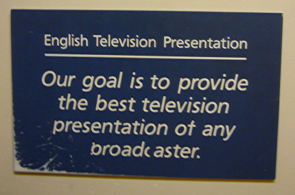 Sign on third floor of Fort Dork Sign reads English Television Presentation: Our goal is to provide the best television presentation of any broadcaster