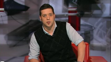 Strombo in sleeveless black caridgan wih faint diamond outlines