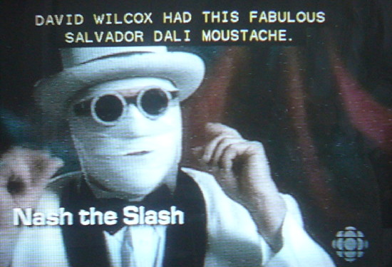 Nash the Slash, face completely bandaged, in round black shades, and wearing a white hat: David Wilcox had this fabulous Salvador DalÃ­ moustache