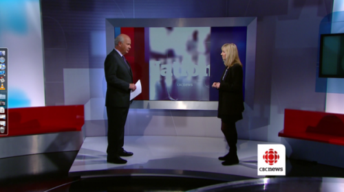 Peter Mansbridge and Kim Fox stand about six feet from each other